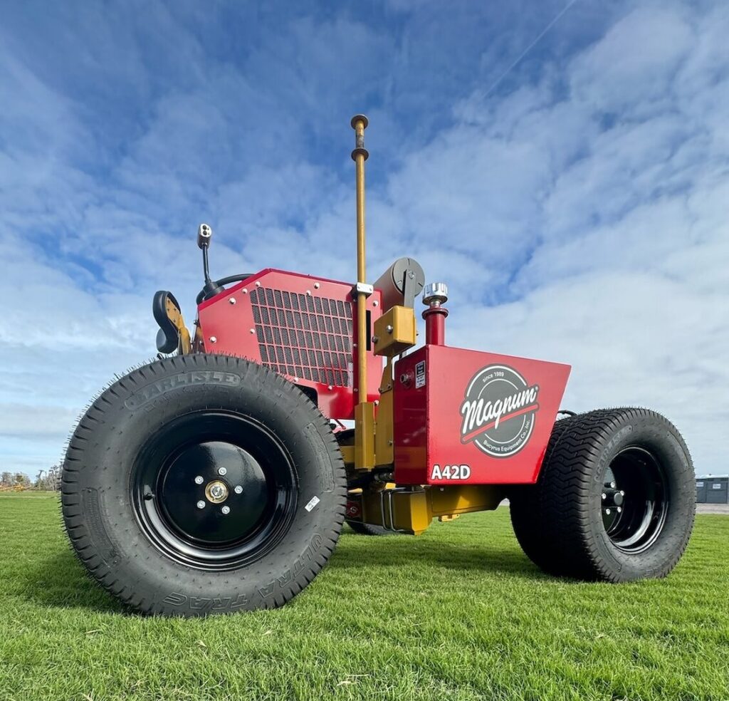 The A-Series Big Roll Sod Installer performs turf field installation on a green field