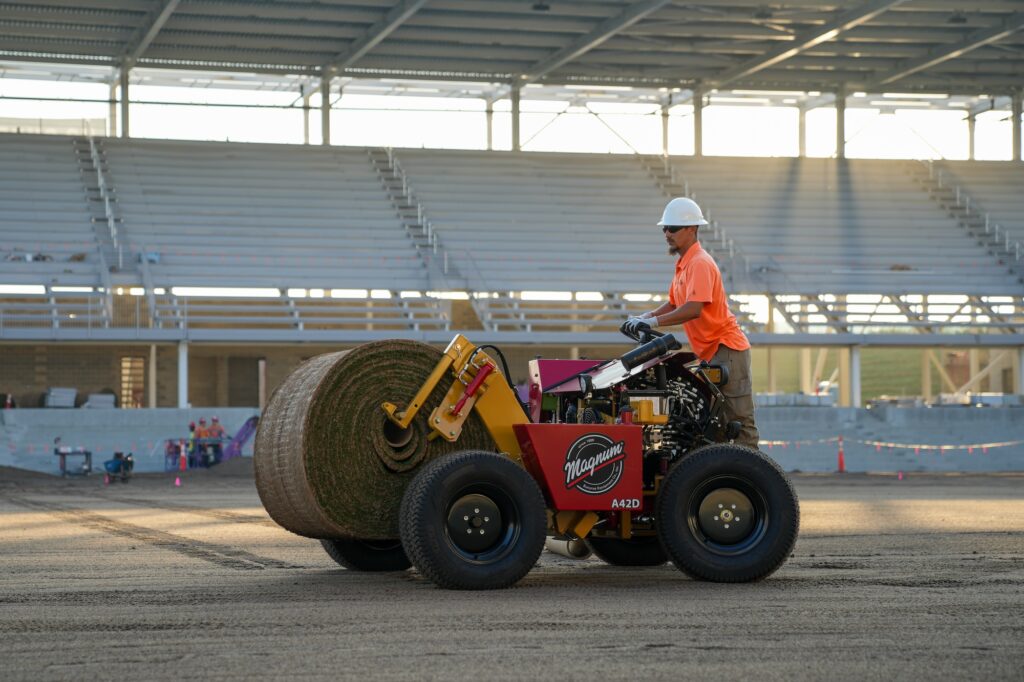 The A-Series turf installer moving a big roll of sod at CPKC stadium in Kansas City.