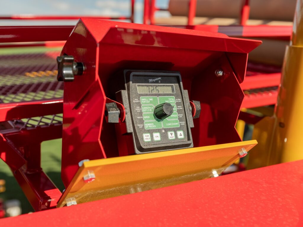 Close-up detail shot of the Magnum II controller mounted on the 420SR Sod Harvester. Digital display shows live harvest parameters including sod dwell time, total distance, big roll sod cut length and big roll sod load count. The SR's control system and harvest automation capabilities help sod farming business.